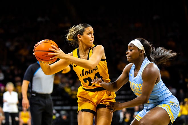 Iowa guard Gabbie Marshall (24) looks to pass as Southern University guard Osha Cummings (23) defends during a NCAA women's basketball game, Monday, Nov. 7, 2022, at Carver-Hawkeye Arena in Iowa City, Iowa.