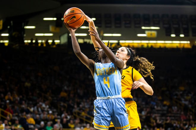 Southern University guard Chloe Fleming (4) drives to the basket as Iowa's McKenna Warnock (14) defends during a NCAA women's basketball game, Monday, Nov. 7, 2022, at Carver-Hawkeye Arena in Iowa City, Iowa.