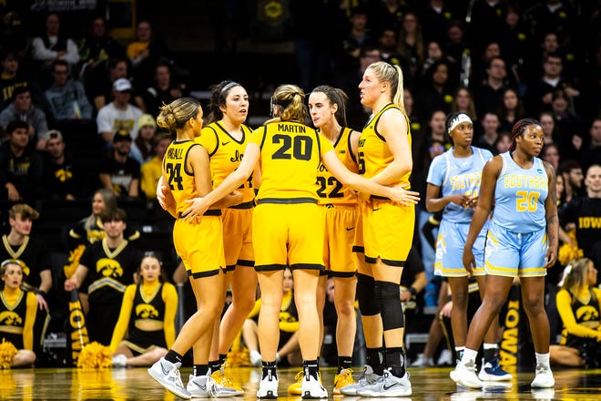 Iowa players, from left, Gabbie Marshall, McKenna Warnock, Kate Martin, Caitlin Clark and center Monika Czinano huddle up during a NCAA women's basketball game against Southern University, Monday, Nov. 7, 2022, at Carver-Hawkeye Arena in Iowa City, Iowa.
