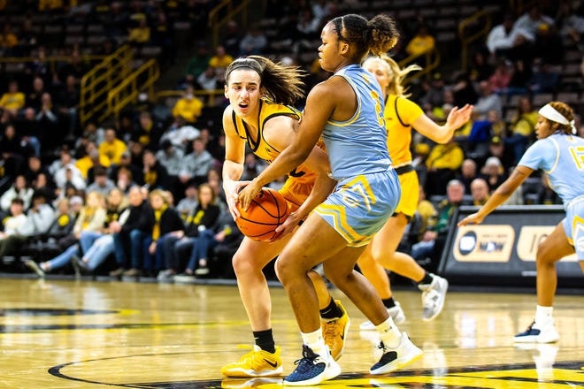 Iowa guard Caitlin Clark, left, gets fouled by Southern University guard Aleighyah Fontenot (2) during a NCAA women's basketball game, Monday, Nov. 7, 2022, at Carver-Hawkeye Arena in Iowa City, Iowa.