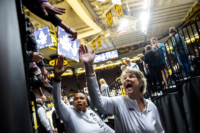 Iowa head coach Lisa Bluder, right, and Iowa assistant coach Raina Harmon high-five fans after a NCAA women's basketball game against Southern University, Monday, Nov. 7, 2022, at Carver-Hawkeye Arena in Iowa City, Iowa.