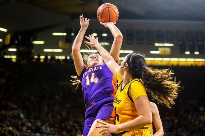 Evansville's Abby Feit, left, gets fouled by Iowa's McKenna Warnock during a NCAA women's basketball game, Thursday, Nov. 10, 2022, at Carver-Hawkeye Arena in Iowa City, Iowa.