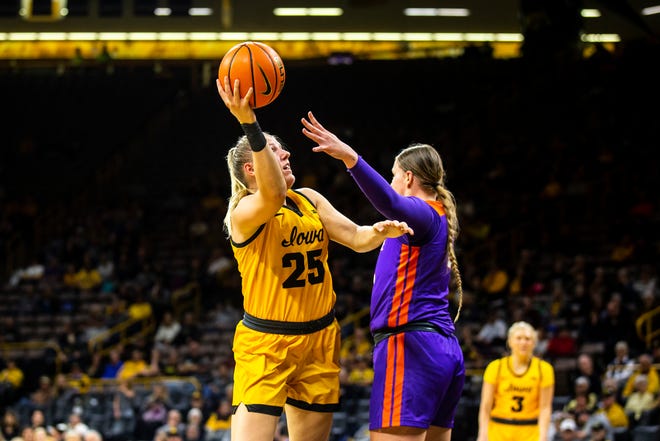 Iowa center Monika Czinano, left, shoots a basket as Evansville center Barbora Tomancova defends during a NCAA women's basketball game, Thursday, Nov. 10, 2022, at Carver-Hawkeye Arena in Iowa City, Iowa.