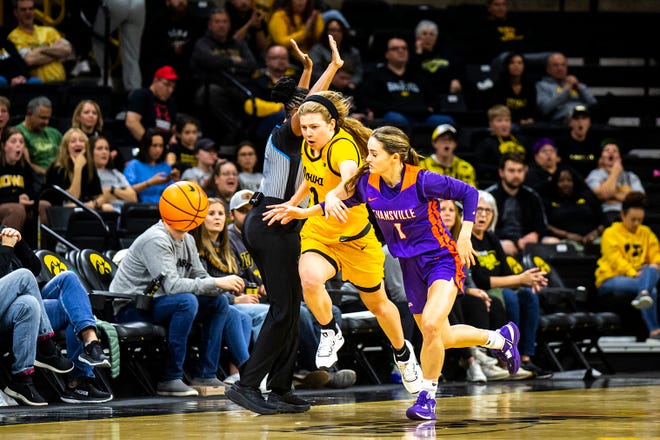 Iowa guard Molly Davis, left, gets a steal as Evansville guard Anna Newman defends during a NCAA women's basketball game, Thursday, Nov. 10, 2022, at Carver-Hawkeye Arena in Iowa City, Iowa.