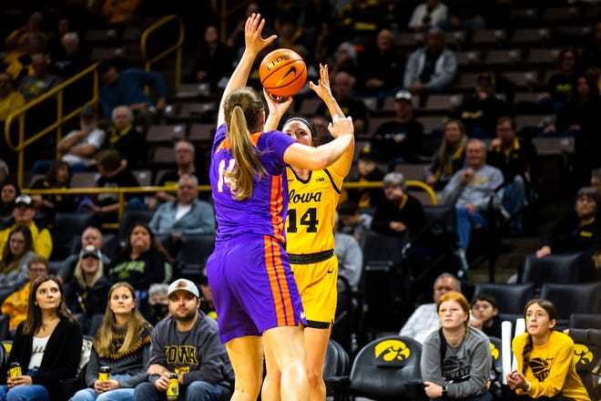 Iowa's McKenna Warnock, right, shoots a 3-point basket as Evansville's Abby Feit defends during a NCAA women's basketball game, Thursday, Nov. 10, 2022, at Carver-Hawkeye Arena in Iowa City, Iowa.