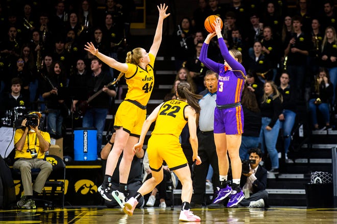 Iowa center Sharon Goodman, left, and Iowa guard Caitlin Clark (22) defend as Evansville center Barbora Tomancova (3) shoots a basket during a NCAA women's basketball game, Thursday, Nov. 10, 2022, at Carver-Hawkeye Arena in Iowa City, Iowa.