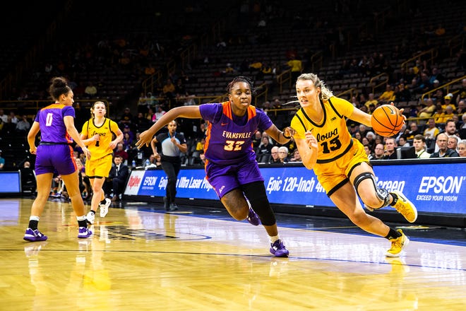 Iowa forward Shateah Wetering (13) drives to the basket as Evansville guard Myia Clark (32) defends during a NCAA women's basketball game, Thursday, Nov. 10, 2022, at Carver-Hawkeye Arena in Iowa City, Iowa.