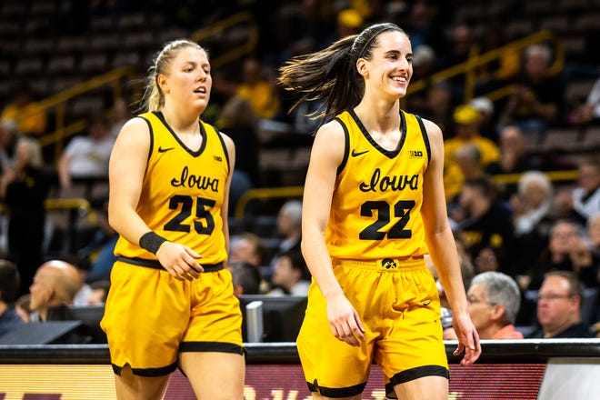 Iowa center Monika Czinano, left, and guard Caitlin Clark (22) walk to the bench during a NCAA women's basketball game against Evansville, Thursday, Nov. 10, 2022, at Carver-Hawkeye Arena in Iowa City, Iowa.