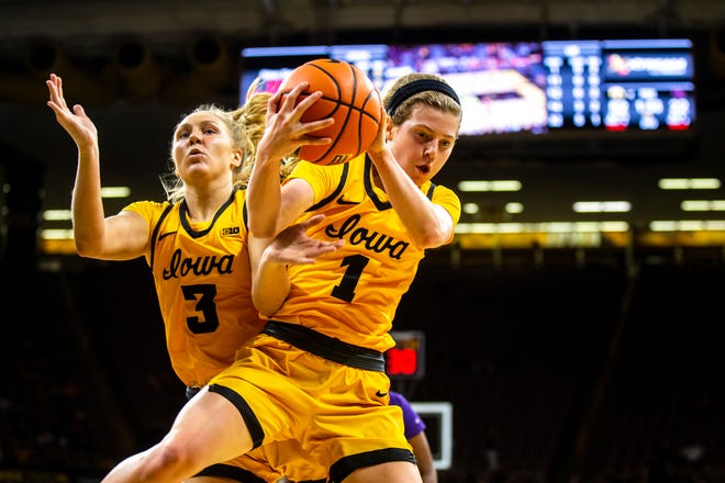 Iowa guards Sydney Affolter, left, and Molly Davis go up for a rebound during a NCAA women's basketball game against Evansville, Thursday, Nov. 10, 2022, at Carver-Hawkeye Arena in Iowa City, Iowa.