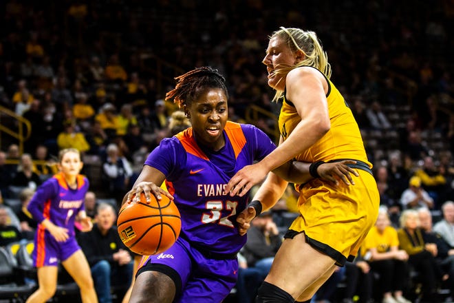 Evansville guard Myia Clark, left, drives to the basket as Iowa center Monika Czinano defends during a NCAA women's basketball game, Thursday, Nov. 10, 2022, at Carver-Hawkeye Arena in Iowa City, Iowa.