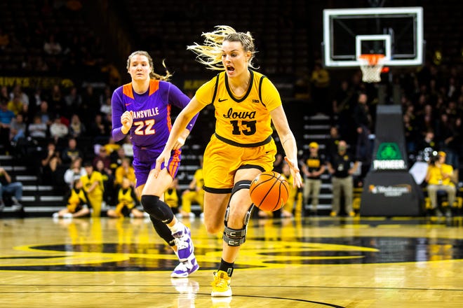 Iowa forward Shateah Wetering (13) dribbles as Evansville forward Jossie Hudson (22) defends during a NCAA women's basketball game, Thursday, Nov. 10, 2022, at Carver-Hawkeye Arena in Iowa City, Iowa.