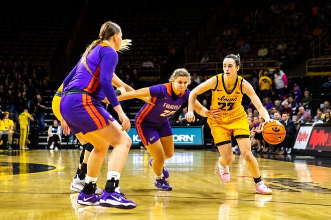 Iowa guard Caitlin Clark (22) drives to the basket as Evansville guard Lexie Sinclair (25) defends during a NCAA women's basketball game, Thursday, Nov. 10, 2022, at Carver-Hawkeye Arena in Iowa City, Iowa.