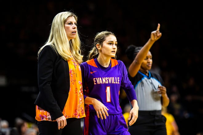 Evansville head coach Robyn Scherr-Wells, left, stands with Evansville guard Anna Newman (1) during a NCAA women's basketball game against Iowa, Thursday, Nov. 10, 2022, at Carver-Hawkeye Arena in Iowa City, Iowa.