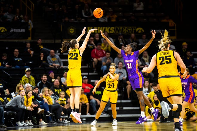 Iowa guard Caitlin Clark (22) shoots a 3-point basket as Evansville guard A'Niah Griffin (21) defends during a NCAA women's basketball game, Thursday, Nov. 10, 2022, at Carver-Hawkeye Arena in Iowa City, Iowa.