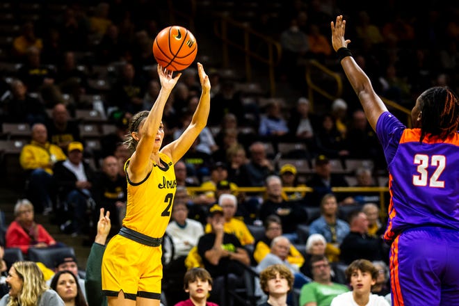 Iowa guard Taylor McCabe (2) shoots a 3-point basket as Evansville guard Myia Clark (32) defends during a NCAA women's basketball game, Thursday, Nov. 10, 2022, at Carver-Hawkeye Arena in Iowa City, Iowa.