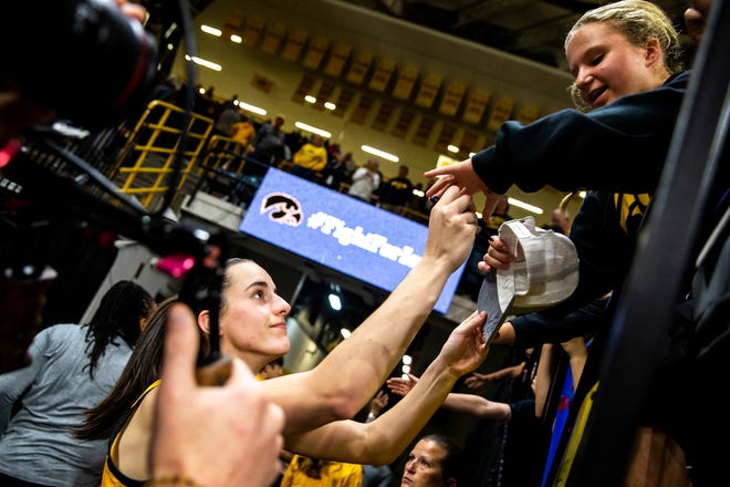 Iowa guard Caitlin Clark signs an autograph for a fan after a NCAA women's basketball game against Evansville, Thursday, Nov. 10, 2022, at Carver-Hawkeye Arena in Iowa City, Iowa.