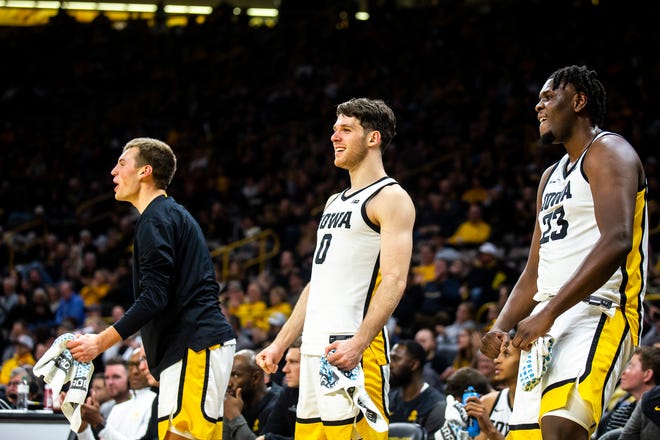 Iowa players, from left, Payton Sandfort, Filip Rebraca and Josh Ogundele celebrate on the bench during a NCAA men's basketball game against North Carolina A&T, Friday, Nov. 11, 2022, at Carver-Hawkeye Arena in Iowa City, Iowa.