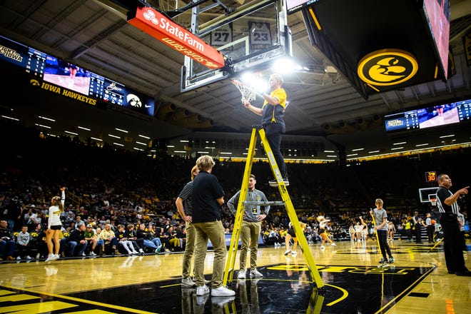 University of Iowa facilities crew members work to repair a net during a NCAA men's basketball game against North Carolina A&T, Friday, Nov. 11, 2022, at Carver-Hawkeye Arena in Iowa City, Iowa.