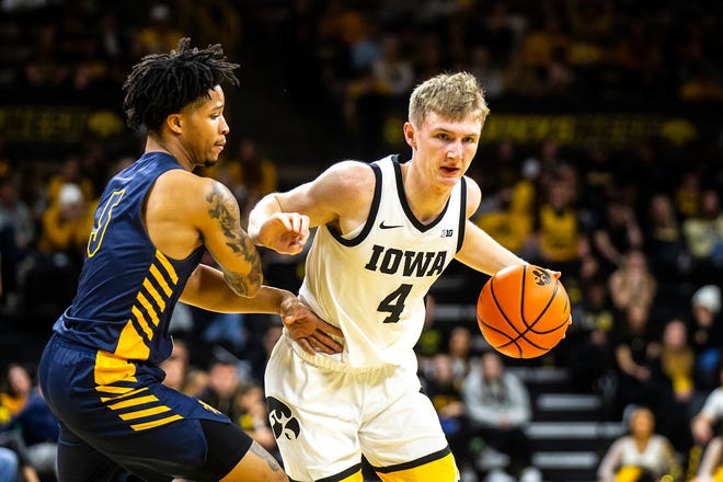 Iowa guard Josh Dix drives to the basket as North Carolina A&T guard Tyrese Elliott defends during a NCAA men's basketball game, Friday, Nov. 11, 2022, at Carver-Hawkeye Arena in Iowa City, Iowa.
