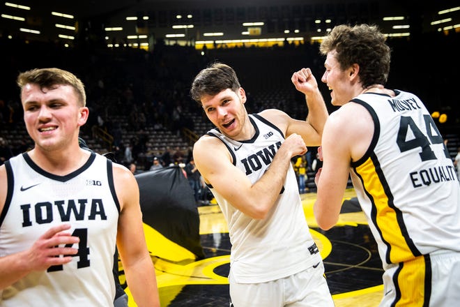 Iowa players Carter Kingsbury, left,  Filip Rebraca and Riley Mulvey celebrate after a NCAA men's basketball game against North Carolina A&T, Friday, Nov. 11, 2022, at Carver-Hawkeye Arena in Iowa City, Iowa.
