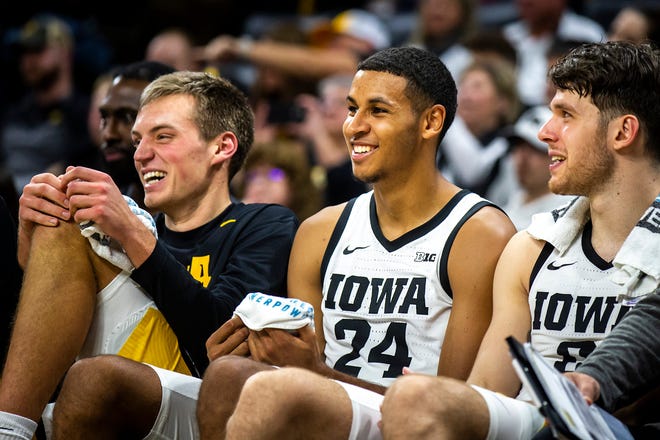 From left, Iowa forwards Payton Sandfort, left, Kris Murray and Filip Rebraca smile on the bench during a NCAA men's basketball game against North Carolina A&T, Friday, Nov. 11, 2022, at Carver-Hawkeye Arena in Iowa City, Iowa.