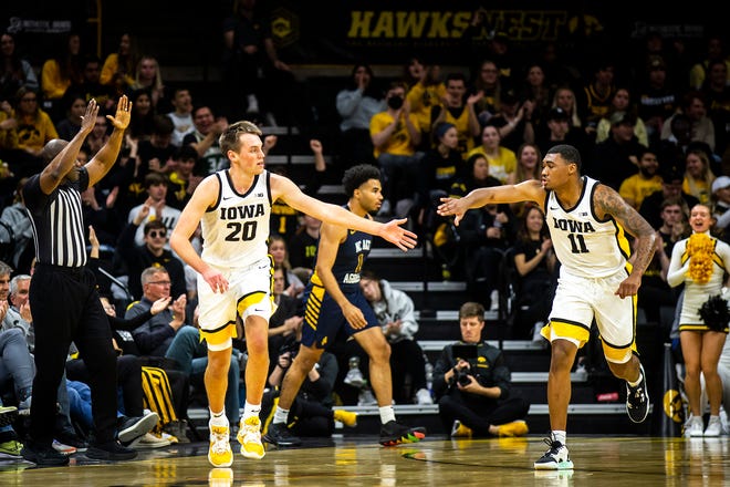 Iowa forward Payton Sandfort, left, gets a high-five from guard Tony Perkins after making a 3-point basket during a NCAA men's basketball game against North Carolina A&T, Friday, Nov. 11, 2022, at Carver-Hawkeye Arena in Iowa City, Iowa.