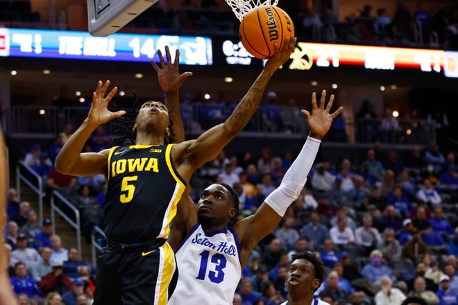 Iowa's Dasonte Bowen, left, attempts a shot as Seton Hall's KC Ndefo defends during the first half of a college basketball game, Wednesday, Nov. 16, 2022, at the Prudential Center in Newark, N.J.