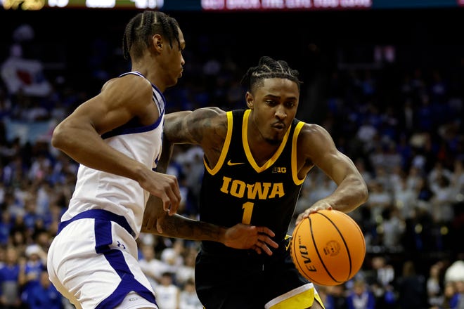 Iowa guard Ahron Ulis (1) drives past Seton Hall guard Dre Davis during the first half of an NCAA college basketball game, Wednesday, Nov. 16, 2022, at the Prudential Center in Newark, N.J.