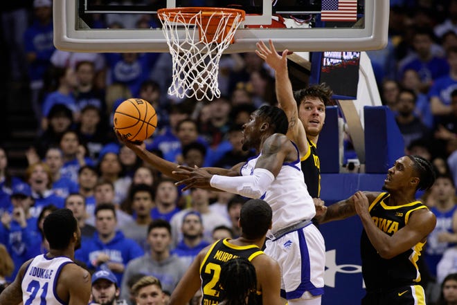 Seton Hall's KC Ndefo attempts a shot as Iowa forward Filip Rebraca, center, and guard Ahron Ulis, right, defend during the first half of a college basketball game, Wednesday, Nov. 16, 2022, at the Prudential Center in Newark, N.J.