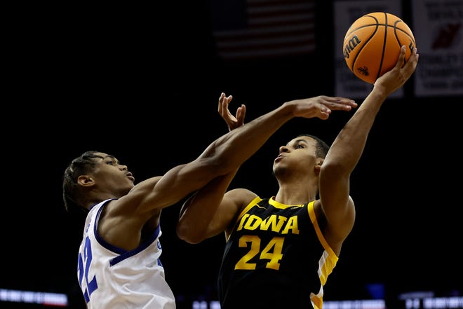 Iowa forward Kris Murray (24) shoots over Seton Hall forward Tae Davis during the first half of an NCAA college basketball game  Wednesday, Nov. 16, 2022, at the Prudential Center in Newark, N.J.