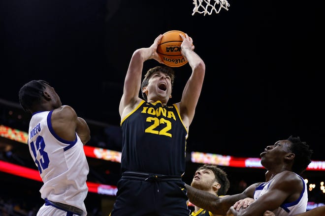 Iowa forward Patrick McCaffery (22) drives to the basket past Seton Hall forward KC Ndefo, left, during the first half of an NCAA college basketball game, Wednesday, Nov. 16, 2022, at the Prudential Center in Newark, N.J.