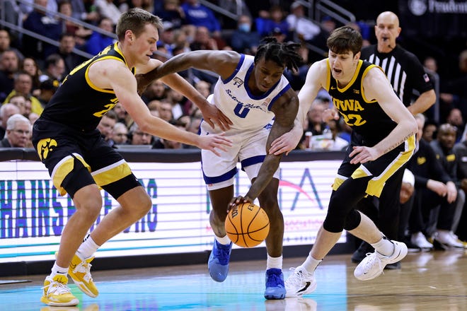 Seton Hall guard Kadary Richmond (0) drives between Iowa's Patrick McCaffery, right, and Payton Sandfort during the second half of an NCAA college basketball game, Wednesday, Nov. 16, 2022, at the Prudential Center in Newark, N.J.