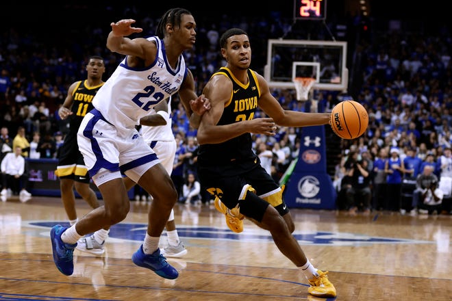 Iowa forward Kris Murray drives past Seton Hall forward Tae Davis (22) during the first half of an NCAA college basketball game, Wednesday, Nov. 16, 2022, at the Prudential Center in Newark, N.J.