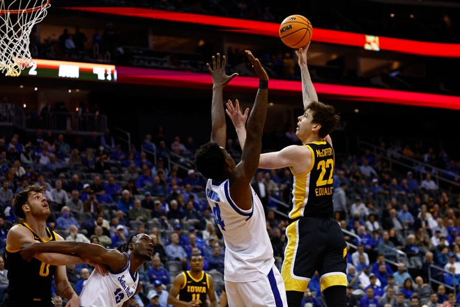 Iowa's Patrick McCaffery, right, attempts a shot as Seton Hall's Tyrese Samuel defends during the first half of a college basketball game, Wednesday, Nov. 16, 2022, at the Prudential Center in Newark, N.J.