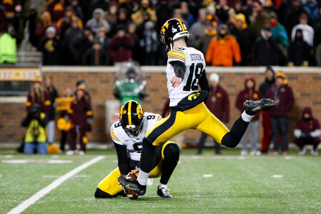 Iowa placekicker Drew Stevens kicks a field goal with a hold from Tory Taylor against the Minnesota Golden Gophers in the fourth quarter, Saturday, Nov. 19, 2022, at Huntington Bank Stadium in Minneapolis, Minn. The Hawkeyes defeated the Golden Gophers 13-10.