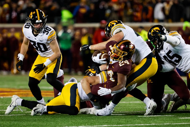Minnesota running back Mohamed Ibrahim gets tackled by a swarm of Iowa Hawkeyes defenders the fourth quarter of the game, Saturday, Nov. 19, 2022, at Huntington Bank Stadium in Minneapolis, Minn.