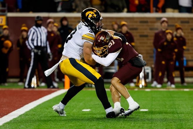 Iowa's Cooper DeJean, left, tackles Minnesota's Quentin Redding short of the goal line in the fourth quarter of the game, Saturday, Nov. 19, 2022, at Huntington Bank Stadium in Minneapolis, Minn.