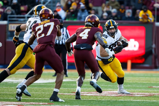 Iowa tight end Luke Lachey runs with the ball while Minnesota's Terell Smith (4) defends in the first quarter of the game, Saturday, Nov. 19, 2022, at Huntington Bank Stadium in Minneapolis, Minn.