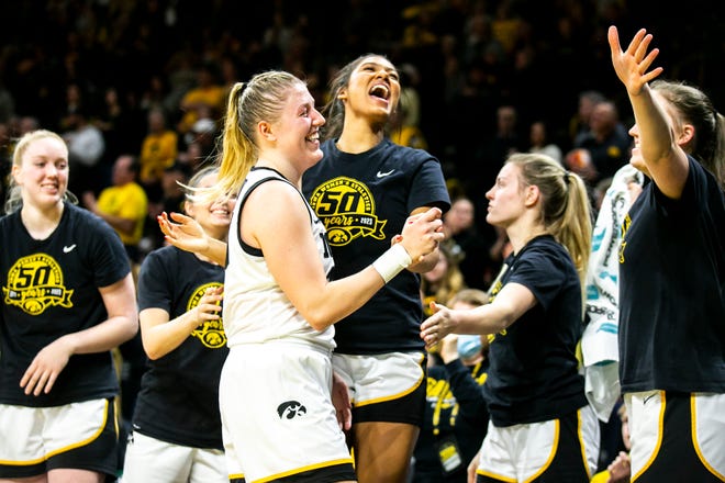 Iowa center Monika Czinano (25) is embraced by forward Jada Gyamfi and teammates during a NCAA Big Ten Conference women's basketball game against Purdue, Thursday, Dec. 29, 2022, at Carver-Hawkeye Arena in Iowa City, Iowa.