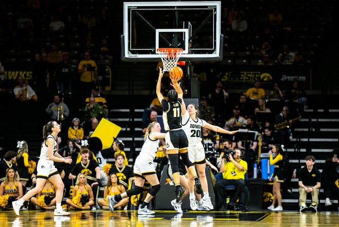Purdue guard Lasha Petree (11) shoots the ball as Iowa guard Kate Martin (20) defends during a NCAA Big Ten Conference women's basketball game, Thursday, Dec. 29, 2022, at Carver-Hawkeye Arena in Iowa City, Iowa.