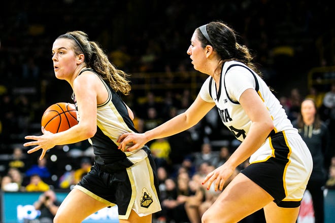 Purdue guard Cassidy Hardin, left, dribbles as Iowa's McKenna Warnock defends during a NCAA Big Ten Conference women's basketball game, Thursday, Dec. 29, 2022, at Carver-Hawkeye Arena in Iowa City, Iowa.