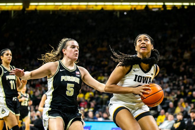 Iowa forward Hannah Stuelke, right, drives to the basket as Purdue guard Cassidy Hardin (5) defends during a NCAA Big Ten Conference women's basketball game, Thursday, Dec. 29, 2022, at Carver-Hawkeye Arena in Iowa City, Iowa.