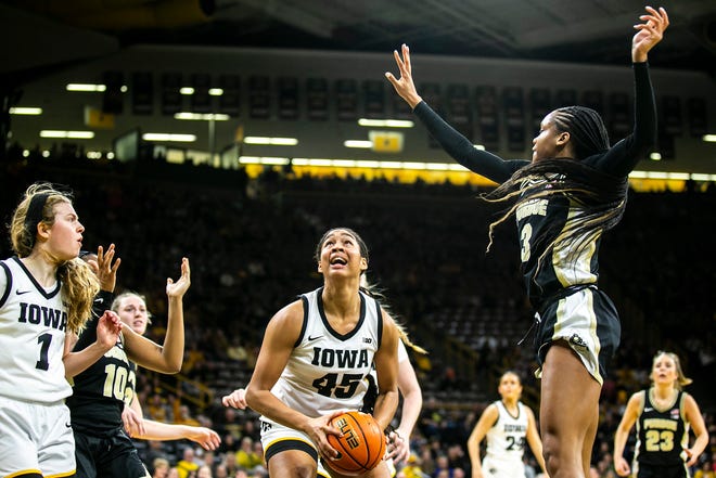 Iowa forward Hannah Stuelke (45) drives to the basket as Purdue guard Jayla Smith (3) defends during a NCAA Big Ten Conference women's basketball game, Thursday, Dec. 29, 2022, at Carver-Hawkeye Arena in Iowa City, Iowa.