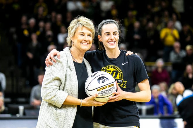 Iowa head coach Lisa Bluder, left, poses for a photo with Iowa guard Caitlin Clark (22) before a NCAA Big Ten Conference women's basketball game against Purdue, Thursday, Dec. 29, 2022, at Carver-Hawkeye Arena in Iowa City, Iowa.