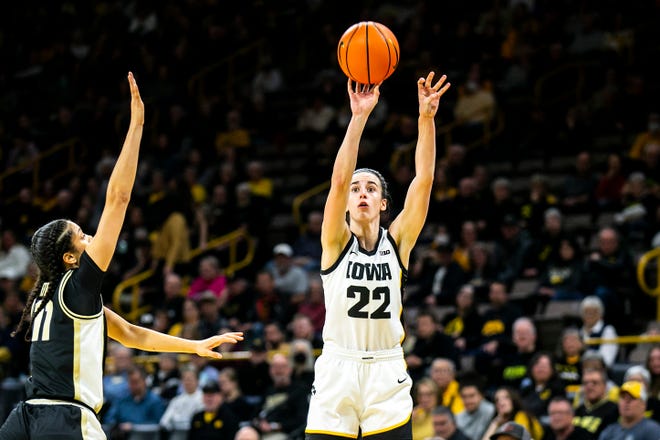 Iowa guard Caitlin Clark (22) shoots a 3-point basket as Purdue guard Lasha Petree defends during a NCAA Big Ten Conference women's basketball game, Thursday, Dec. 29, 2022, at Carver-Hawkeye Arena in Iowa City, Iowa.