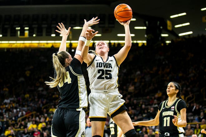 Iowa center Monika Czinano (25) shoots a basket as Purdue forward Caitlin Harper defends during a NCAA Big Ten Conference women's basketball game, Thursday, Dec. 29, 2022, at Carver-Hawkeye Arena in Iowa City, Iowa.