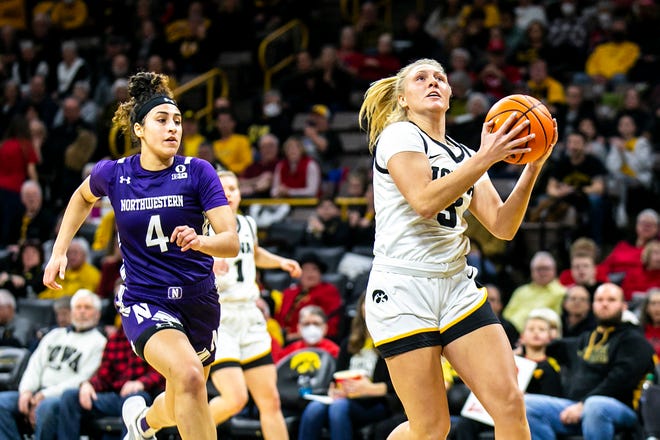 Iowa guard Sydney Affolter, right, drives to the basket as Northwestern guard Jillian Brown defends during a NCAA Big Ten Conference women's basketball game, Wednesday, Jan. 11, 2023, at Carver-Hawkeye Arena in Iowa City, Iowa.