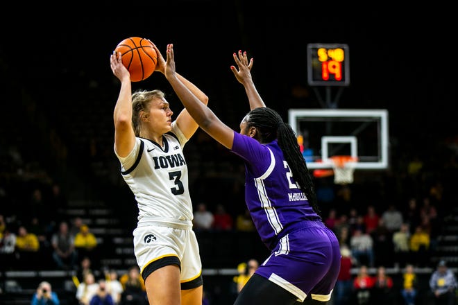 Iowa guard Sydney Affolter, left, looks to pass as Northwestern guard Jasmine McWilliams defends during a NCAA Big Ten Conference women's basketball game, Wednesday, Jan. 11, 2023, at Carver-Hawkeye Arena in Iowa City, Iowa.