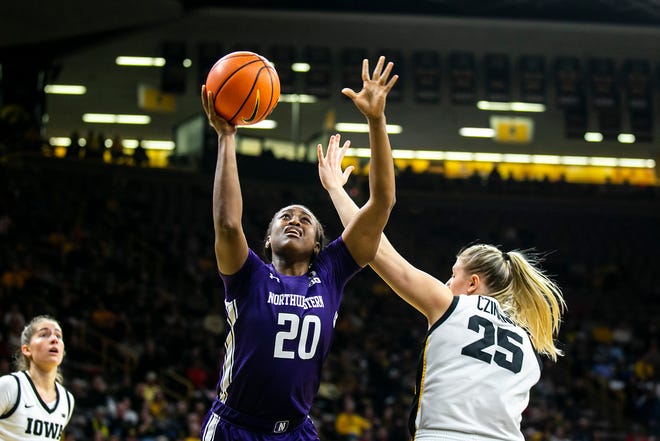 Northwestern forward Paige Mott (20) shoots a basket as Iowa center Monika Czinano (25) defends during a NCAA Big Ten Conference women's basketball game, Wednesday, Jan. 11, 2023, at Carver-Hawkeye Arena in Iowa City, Iowa.