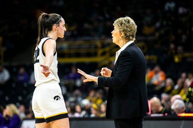 Iowa guard Caitlin Clark, left, talks with head coach Lisa Bluder during a NCAA Big Ten Conference women's basketball game against Northwestern, Wednesday, Jan. 11, 2023, at Carver-Hawkeye Arena in Iowa City, Iowa.